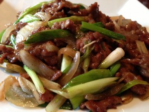 Mongolian Beef - flank steak, onions, scallions, on a bed of house made spinach noodles